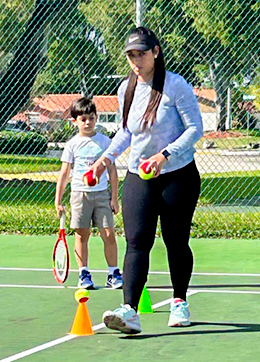 tennis coach with students