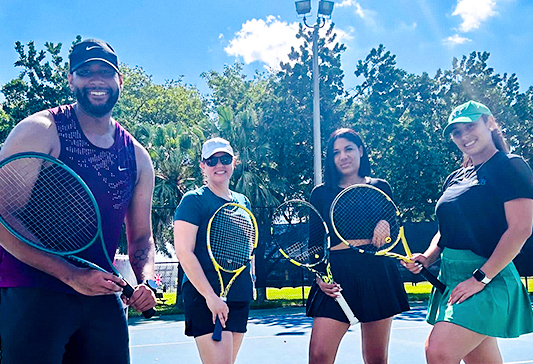 tennis coach with students